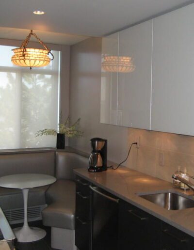 Modern kitchen with stainless steel appliances and pendant lighting.